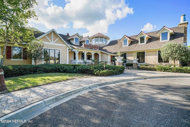 3107 Forest View Ln, Green Cove Springs, FL 32043 - view of front of house with a front yard, a chimney, and covered porch