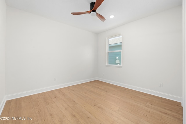 empty room featuring ceiling fan and light hardwood / wood-style flooring