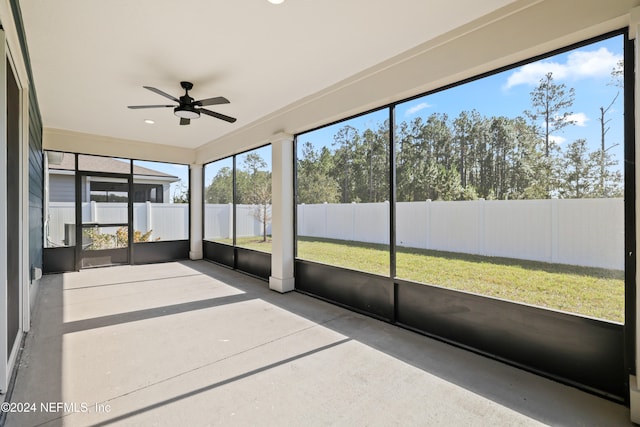 unfurnished sunroom featuring ceiling fan