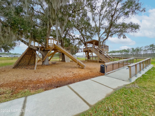 view of playground with a water view