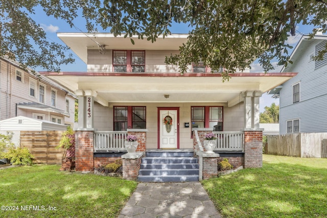 view of front of property with a porch and a front yard