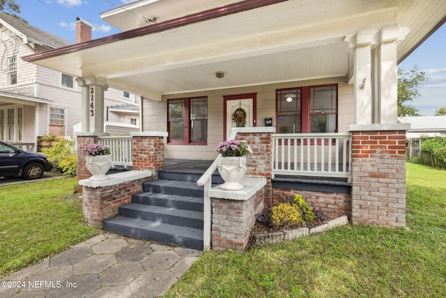 view of front of home with a porch and a front yard