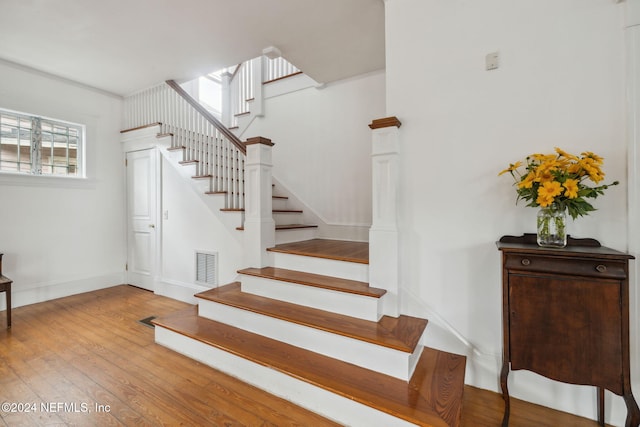 stairs with hardwood / wood-style floors