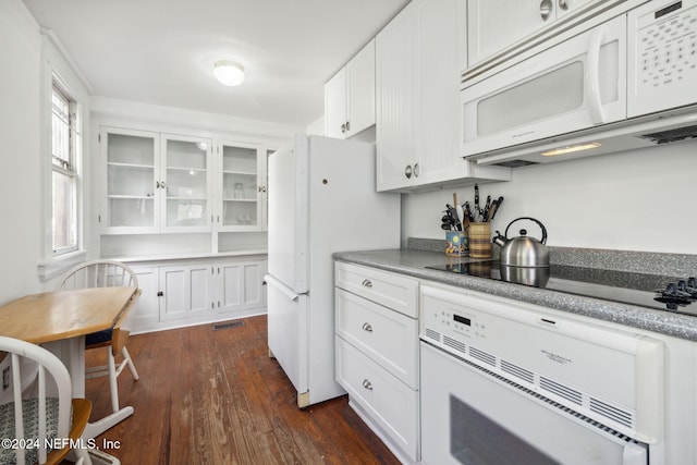 kitchen with white cabinetry, dark wood-type flooring, and white appliances