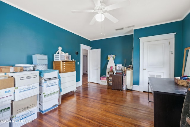 bedroom with ceiling fan, crown molding, and dark hardwood / wood-style floors