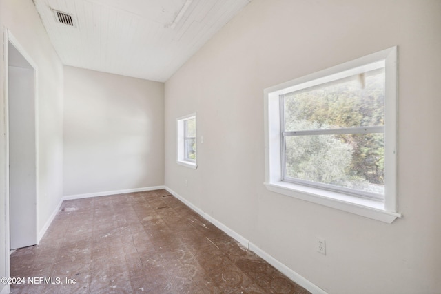 spare room featuring vaulted ceiling