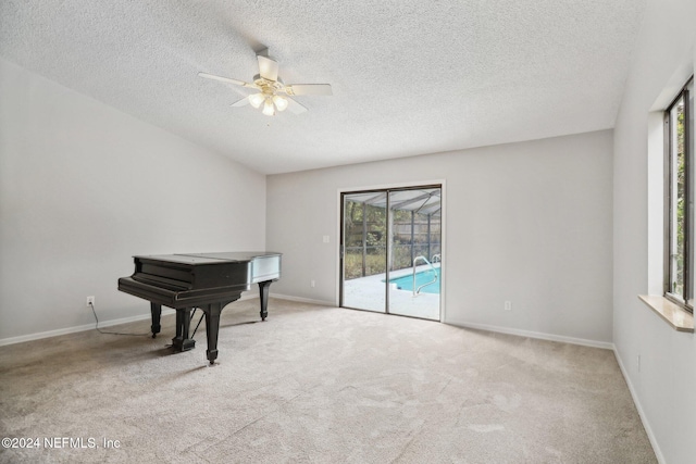 miscellaneous room featuring ceiling fan, a healthy amount of sunlight, and light carpet