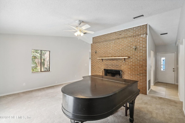 living room with carpet flooring, a healthy amount of sunlight, lofted ceiling, and a brick fireplace