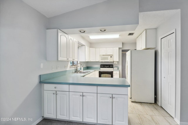 kitchen with kitchen peninsula, white appliances, sink, light tile patterned floors, and white cabinetry