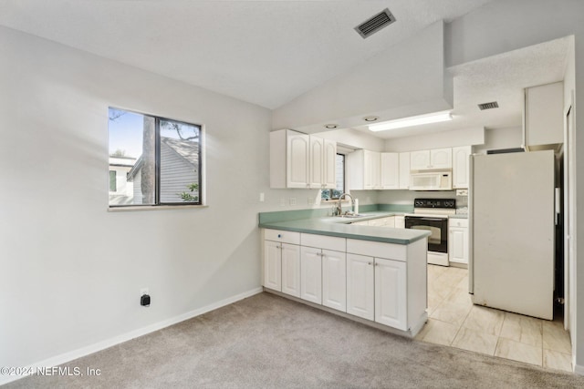 kitchen with lofted ceiling, white cabinetry, light carpet, and white appliances