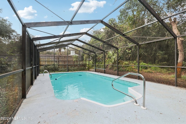 view of swimming pool featuring a lanai and a patio