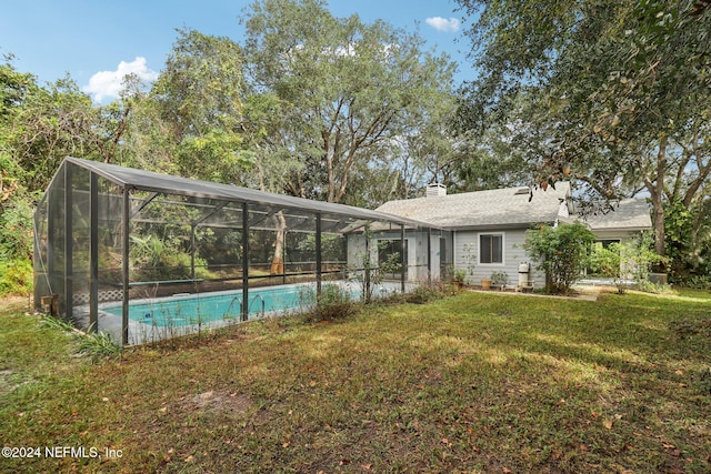 exterior space featuring a lanai and a yard