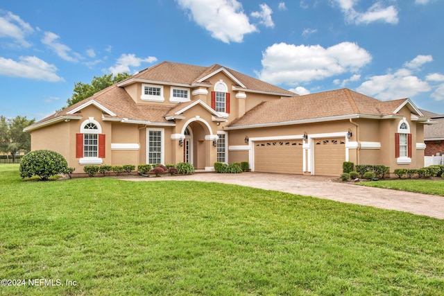 view of front of house featuring a garage and a front yard