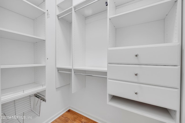 spacious closet featuring hardwood / wood-style floors