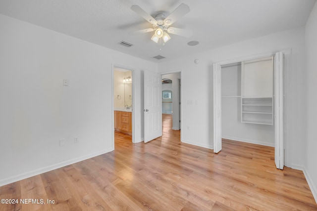 unfurnished bedroom with light hardwood / wood-style floors, ceiling fan, and a closet