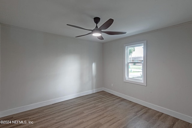 unfurnished room with light hardwood / wood-style floors, ceiling fan, and crown molding