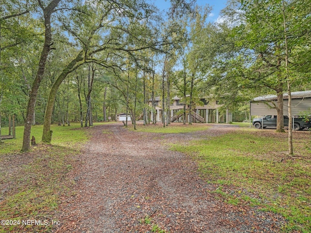 exterior space with a playground and a front yard