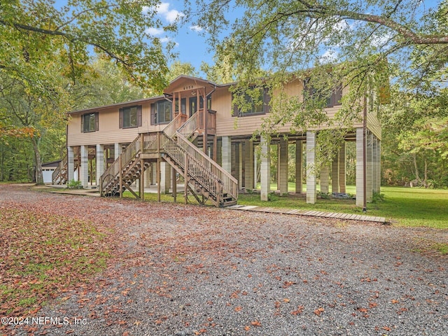 coastal home with a front lawn and a garage