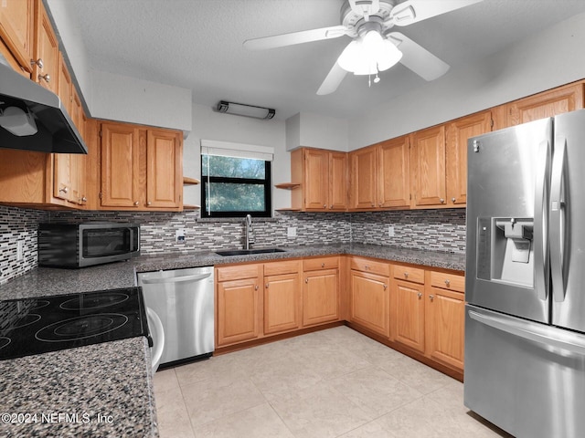 kitchen featuring stainless steel appliances, backsplash, light tile patterned floors, sink, and ceiling fan