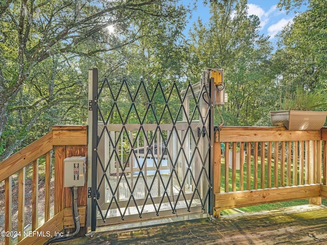 view of gate with a wooden deck