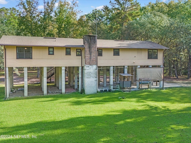 back of property featuring a patio and a yard