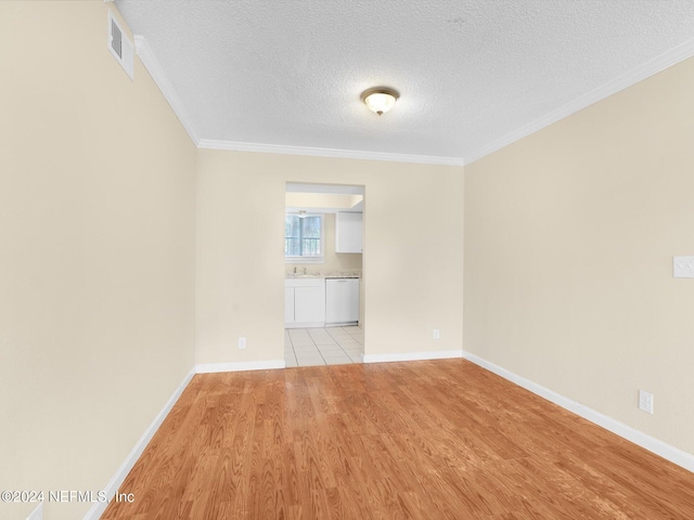 unfurnished room featuring crown molding, sink, a textured ceiling, and light hardwood / wood-style floors