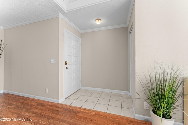 entryway featuring crown molding, light hardwood / wood-style floors, and a textured ceiling