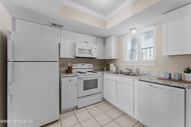 kitchen featuring white appliances, sink, and white cabinets