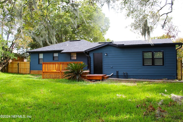 back of house with a lawn and a wooden deck