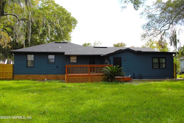 back of property with a lawn and a wooden deck