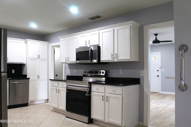 kitchen with white cabinets, ceiling fan, light hardwood / wood-style floors, and stainless steel appliances