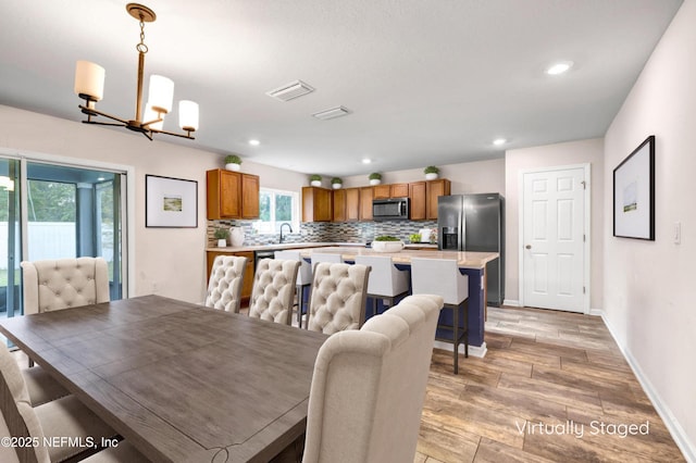 dining room with sink and an inviting chandelier