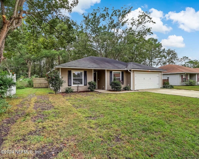 single story home featuring a garage and a front lawn