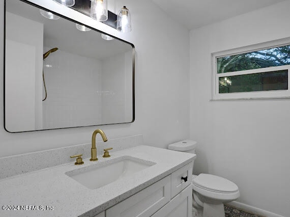 bathroom featuring toilet and vanity