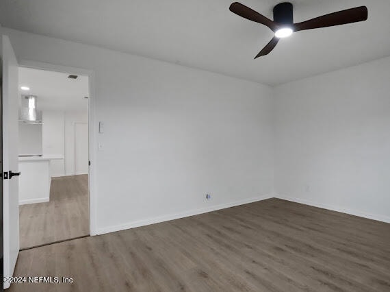 unfurnished room featuring hardwood / wood-style flooring and ceiling fan