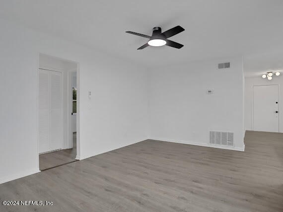 spare room with wood-type flooring and ceiling fan