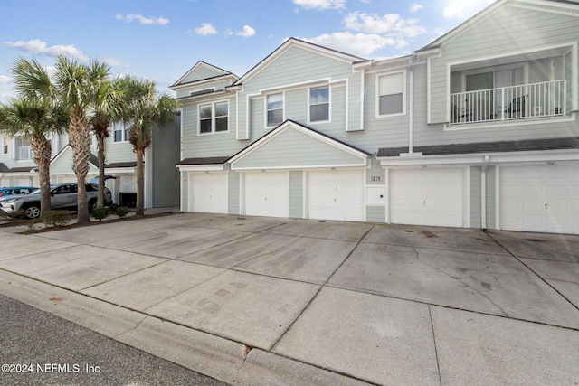 view of front of home with a balcony and a garage