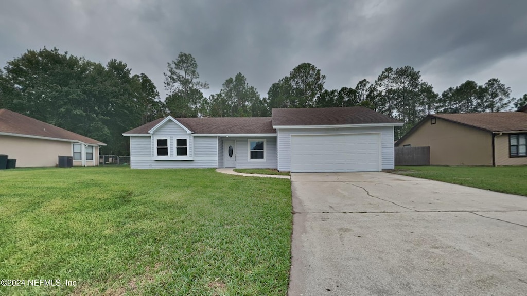 single story home featuring central air condition unit, a garage, and a front lawn