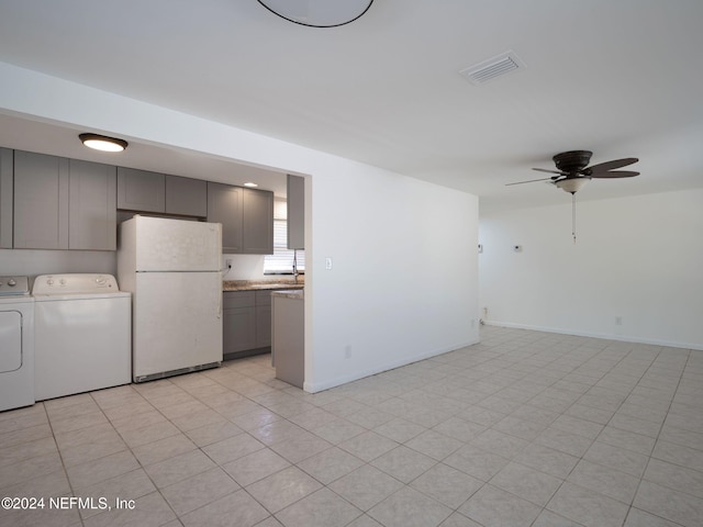 interior space with separate washer and dryer, white refrigerator, light tile patterned floors, gray cabinets, and ceiling fan