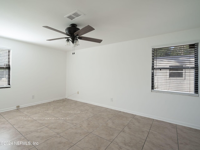 tiled empty room with ceiling fan