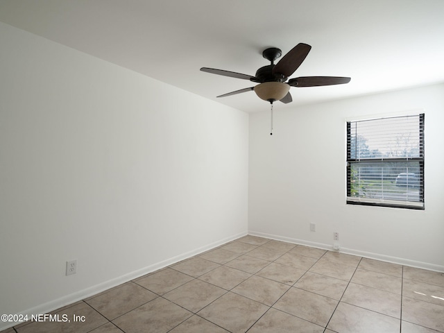 unfurnished room featuring ceiling fan and light tile patterned floors