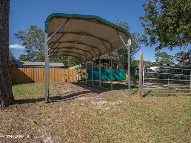 view of vehicle parking featuring a yard and a carport