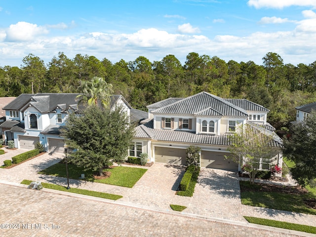 mediterranean / spanish-style house with a garage