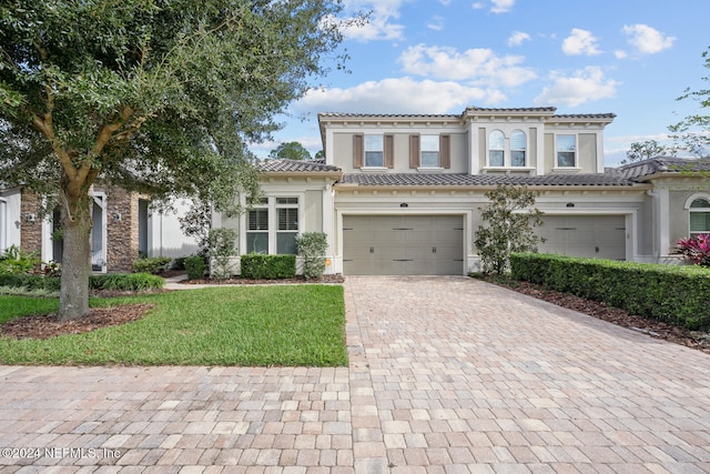 mediterranean / spanish-style home featuring a garage