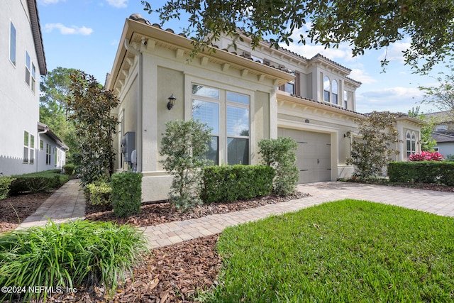 view of front of property with a garage and a front lawn