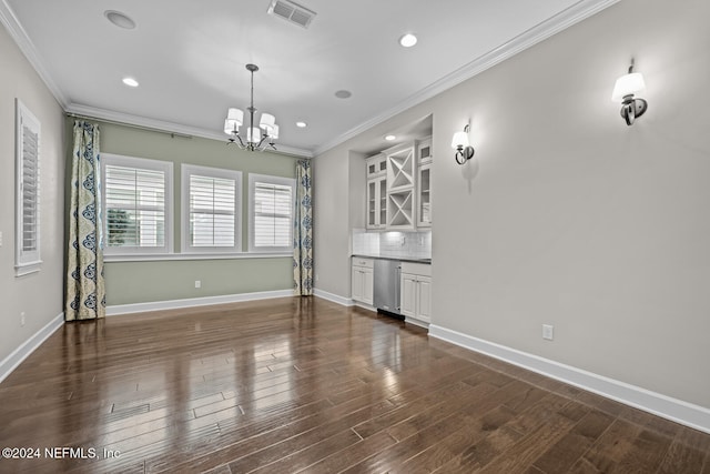 interior space featuring a notable chandelier, dark hardwood / wood-style flooring, and ornamental molding