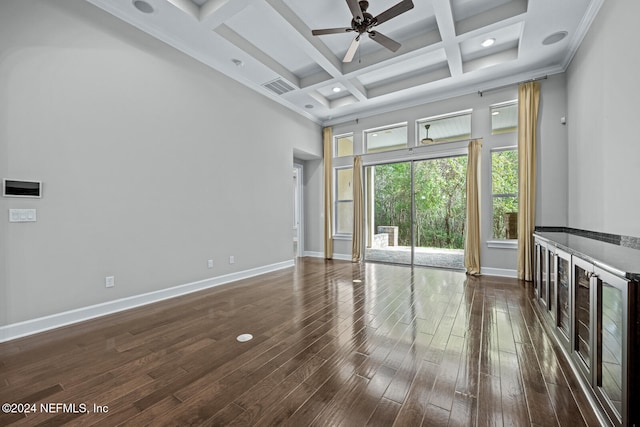 unfurnished living room with coffered ceiling, ceiling fan, dark wood-type flooring, crown molding, and beam ceiling