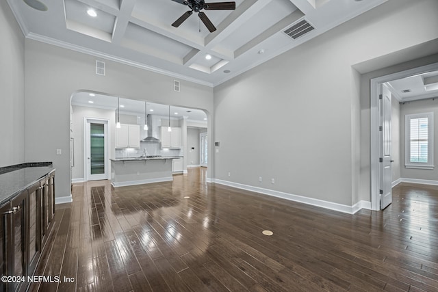 living room featuring beamed ceiling, dark hardwood / wood-style floors, crown molding, and coffered ceiling