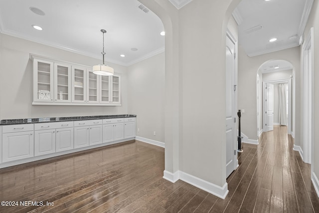 hallway featuring dark hardwood / wood-style flooring and ornamental molding