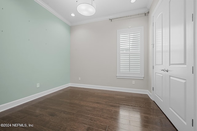 unfurnished room with crown molding and dark hardwood / wood-style flooring